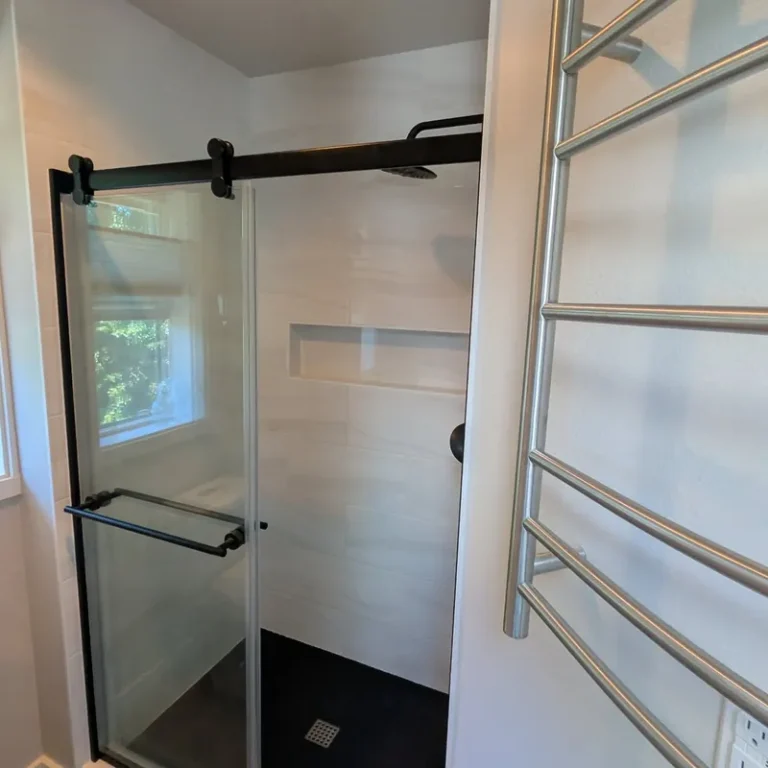 Sliding glass shower door and heated towel rack